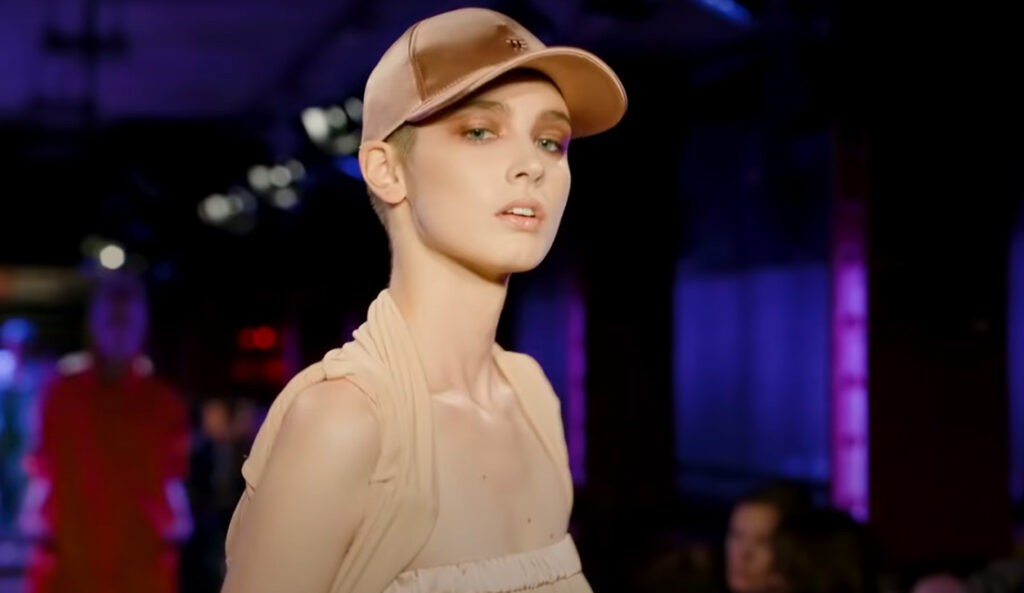 Tom Ford Spring Summer 2020. Model, woman with light green eyes wearing a beige top and beige hat, womenswear.