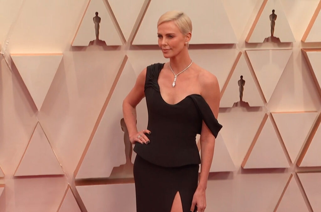 On the 2020 Academy Awards Red Carpet Beautiful Charlize Theron Wearing a Black Dress by Dior - A stylish woman in Hollywood