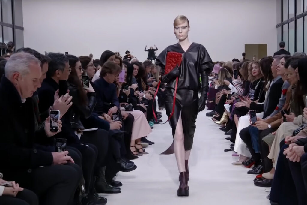 Black leather outfit with a red leather bag. A Symphony of Fashion with The Fall Winter 2020 Collection by Valentino