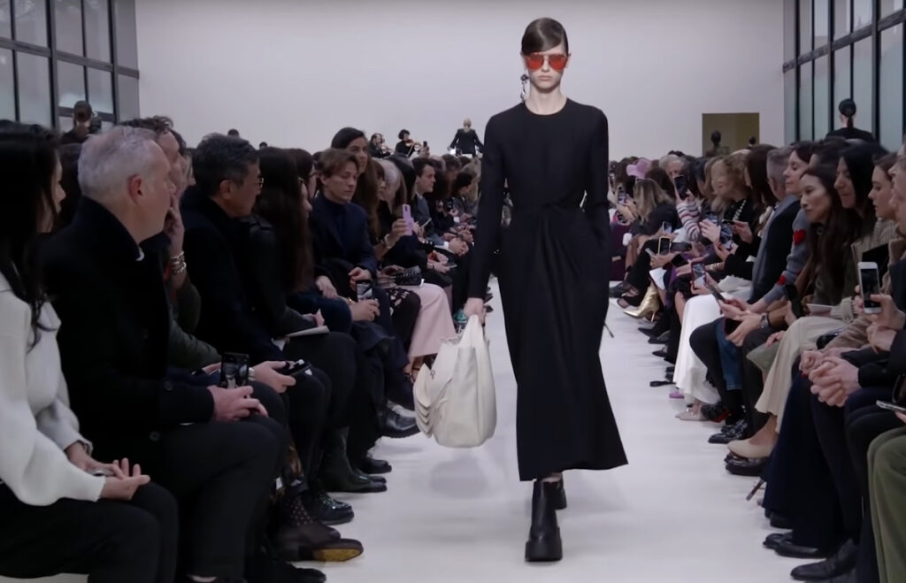 Stylish black dress and pink sunglases look. A Symphony of Fashion with The Fall Winter 2020 Collection by Valentino
