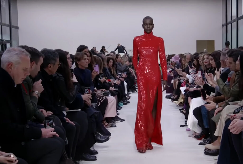 Red dress with a high collar. A Symphony of Fashion with The Fall Winter 2020 Collection by Valentino