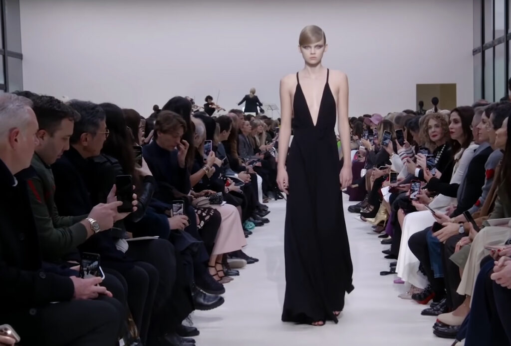 Deep V formal evening wear black dress. A Symphony of Fashion with The Fall Winter 2020 Collection by Valentino