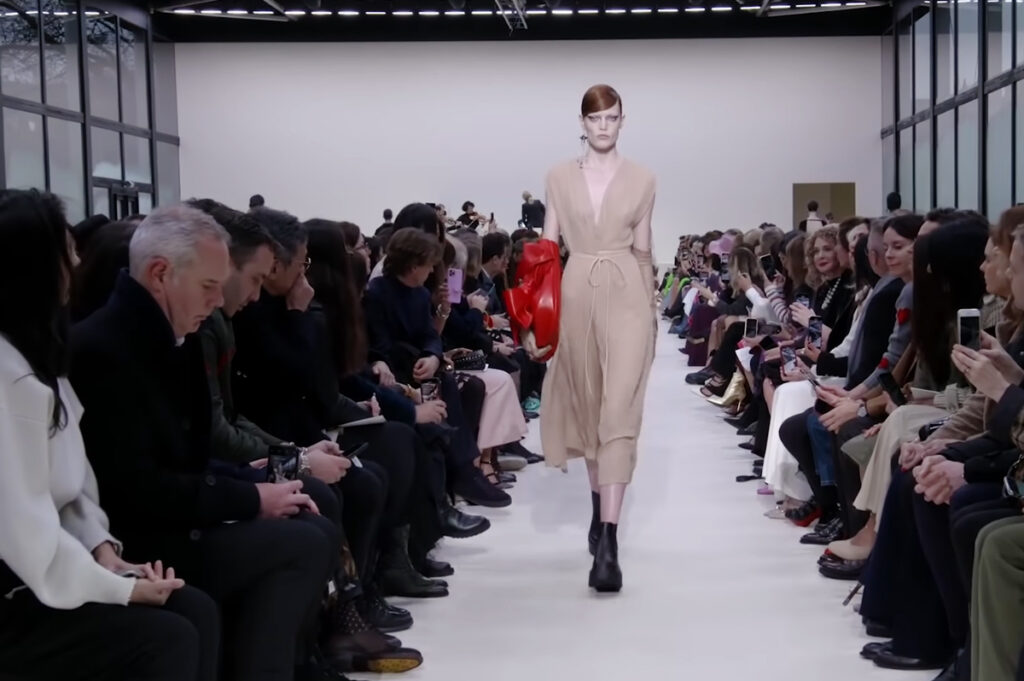 Beige dress with a red handbag. A Symphony of Fashion with The Fall Winter 2020 Collection by Valentino