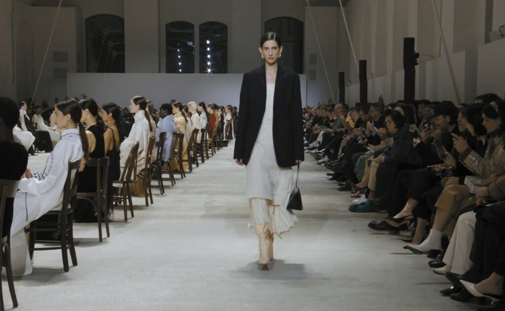 Black blazer and a white dress. Business chic look for women. Refined Design with Jil Sander Fall Winter 2020