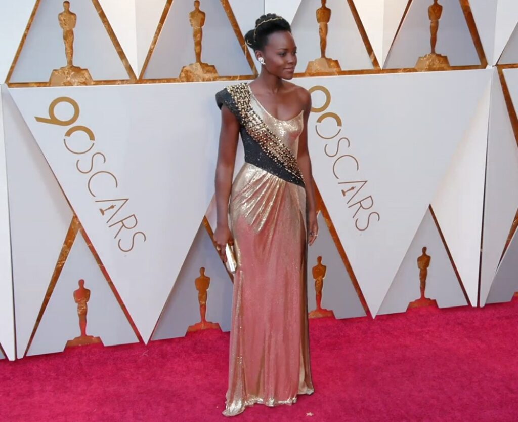 Lupita Nyong'o rocking a golden Versace dress at the 2018 Oscars.