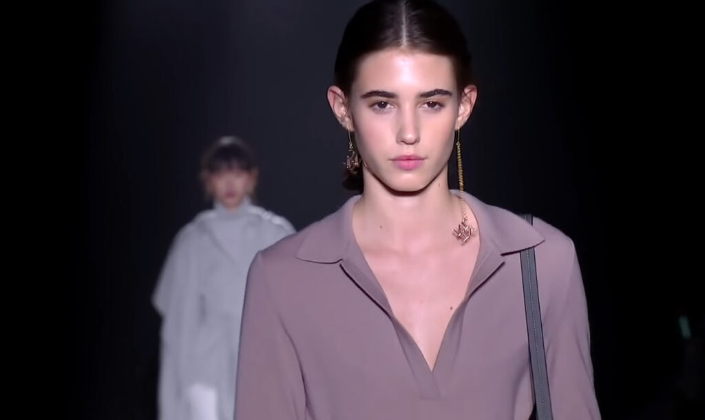 Close-up shot of a model on the runway wearing minimal makeup for a natural look. Harmony and Beauty from Barcelona with Naulover Fall Winter 2020/ 2021
